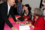 Steven Levy, founder of Festival of Canadian Fashion and the One-of-a-Kind show gets his book signed by Marilyn Brooks. Photo by Toni Coles.